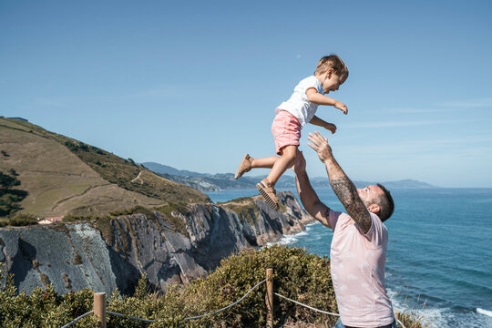 family with 2 children enjoying the beach and cliffs of the Basque country