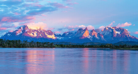 Fototapeta na wymiar Panorama sunrise of the Serrano river with the Andes peaks of Torres del Paine, Patagonia, Chile.