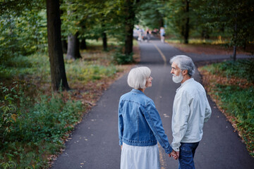 Fototapeta premium Senior family couple walking together at summer park.