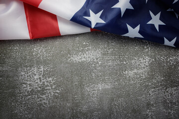 Flat lay, top view United States of America flag is on top of dark gray stone background with copy...