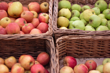 Boxes of juicy apples in the supermarket. Photo on the theme of fruit.