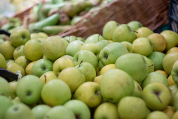 Boxes of juicy apples in the supermarket. Photo on the theme of fruit.