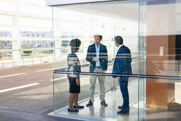 Expertise team having discussion while standing in modern office