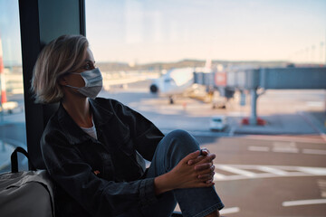 New normal and social distance concept. Young woman tourist wearing face mask during corona virus...