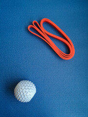 Blue ball and red ribbon on the background of the training mat