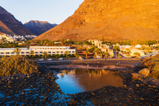 Spain, Valle Gran Rey, Drone view of town at edge of La Gomera island at dusk