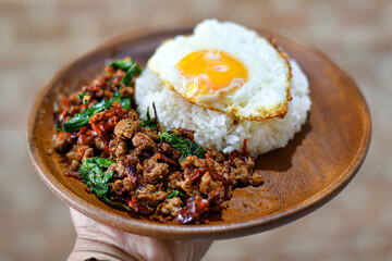 Rice topped with stir-fried beef and basil and fried egg
