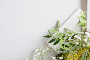 spring mimosa flowers and wooden frame on grey background, flat lay