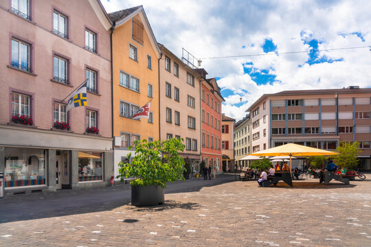 Kornplatz square with restaurants and cafes against cloudy sky at Chur, Switzerland