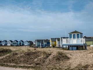 Fototapeta na wymiar beach huts in the sand dunes at Mudeford Dorset