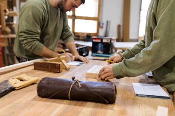 Craftsmen working at table in workshop