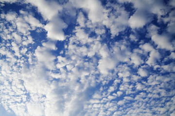 Open Small air clouds in the dark blue sky