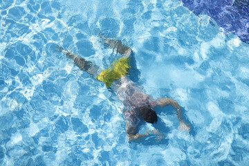Man lies at bottom of pool closeup