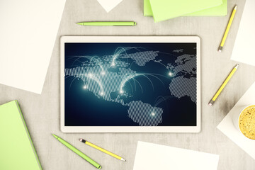 Top view of modern digital tablet monitor with abstract world map with connections, research and strategy concept. 3D Rendering