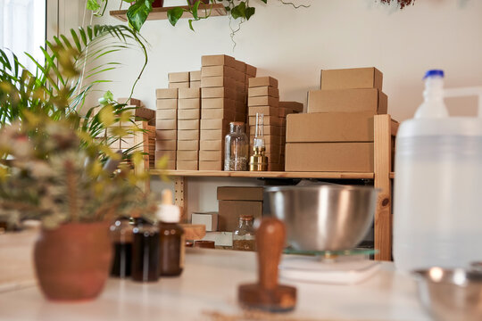Organic soap boxes stacked on rack in workshop