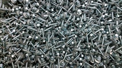 Background or texture of roofing screws with drill and rubber washer