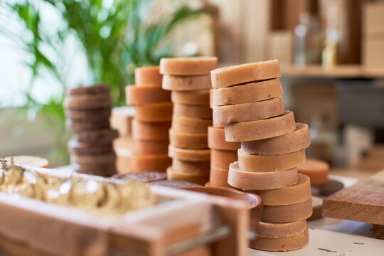 Organic soaps piled up on table at workshop
