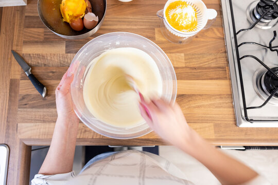 Woman stirring cheesecake filling