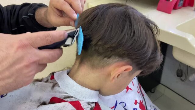 Little boy getting a haircut. 4K