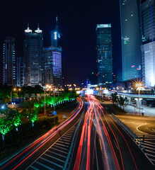 Fototapeta premium Red lights of car in motion, Shanghai downtown night
