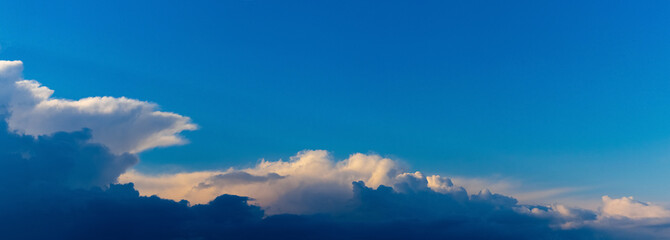Blue sky with light and dark clouds in the evening, panorama