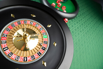 Casino theme.  Roulette wheel on green table.