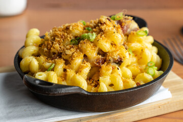 Hearty macaroni and cheese. Homemade dish of mac and cheese made with real cheddar cheese and topped with bread crumbs. 