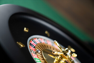 Casino theme.  Roulette wheel on green table.