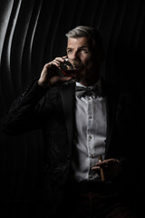 Portrait of a gentleman drinking a glass of alcohol