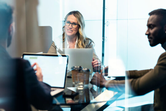 Businesswoman smiling while working with colleague in office