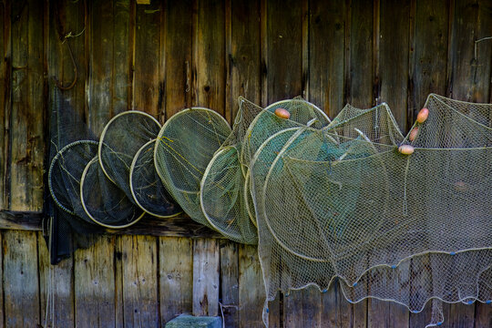 Germany, Bavaria, Diessen am Ammersee, Fishing nets hanging at boathouse