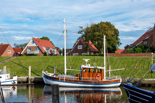 Germany, Lower Saxony, Greetsiel, Fishing boat moored along town harbor
