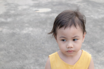 Asian girl, little toddler child with adorable short hair making frustrated face.