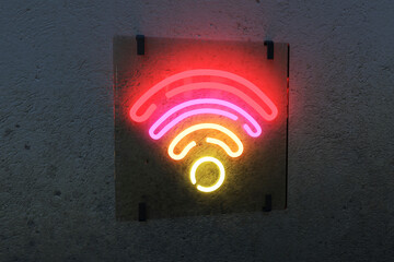 Illuminated WiFi sign against black wall