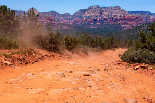 Empty footpath Devil's Bridge Trailhead against rocky mountains on sunny day, Red Rocks, Sedona, Arizona, USA