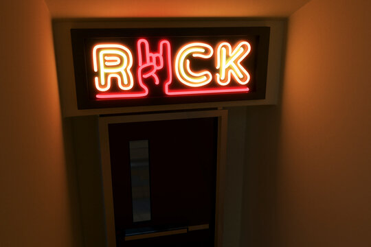 Illuminated rock text with horn sign on door