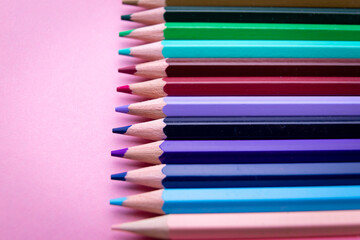 Colorful pencil set on pink background