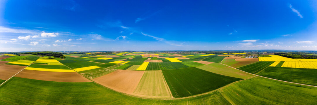 Germany, Hesse, Munzenberg, Helicopter panorama of green and yellow countryside fields in summer