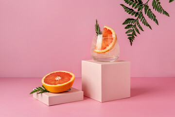 Refreshing colorful summer drink with grapefruit on pink background with shadow fern. Paloma cocktail. - obrazy, fototapety, plakaty