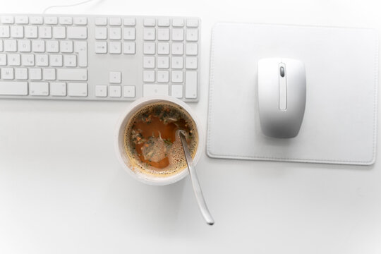 Instant noodles cup with computer keyboard and mouse on desk at home office
