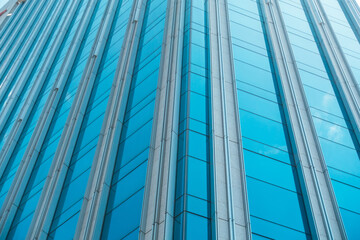 Fototapeta na wymiar underside panoramic and perspective view to steel blue glass high rise building skyscrapers, business concept of successful industrial architecture