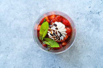 Delicious Italian Dessert Panna Cotta with Strawerry Sauce, Meringue and Fresh Mint Leaves.