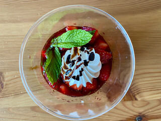 Delicious Italian Dessert Panna Cotta with Strawerry Sauce, Meringue and Fresh Mint Leaves.