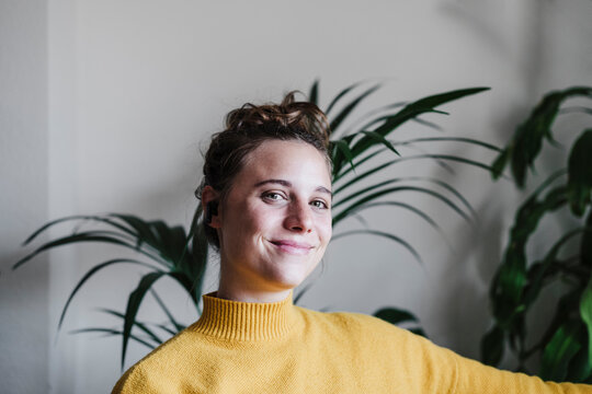 Young woman smiling while sitting at home
