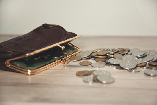  wallet with coins on desk