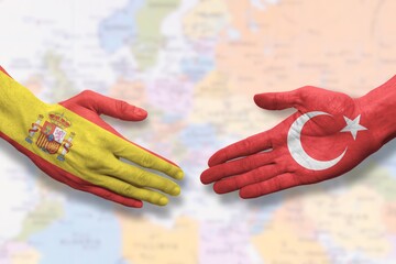 Turkey and Spain - Flag handshake symbolizing partnership and cooperation