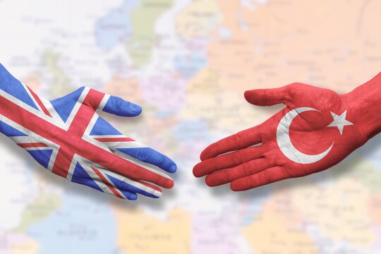 Turkey and UK - Flag handshake symbolizing partnership and cooperation with the United Kingdom