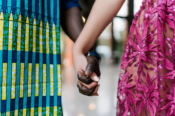 Young couple holding hands while standing at banquet