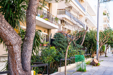 beautiful streets of Athens with blocks of flats, cars and shops