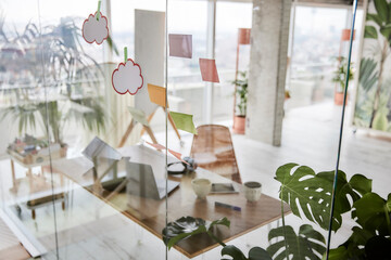 Adhesive notes on glass wall at office